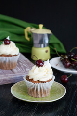 A tasty treat: frosted cupcakes with cherries on top.