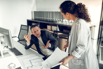 Female boss shouting at her employee for not working