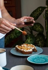 A tasty breakfast fowr two: rye bread sandwiches, honey and fresh coffee.