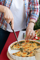 A gourmet lunch: spinach pie with cheese, a salad and wine.
