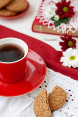 A tasty break: a cup of tea and a plate of cookies.