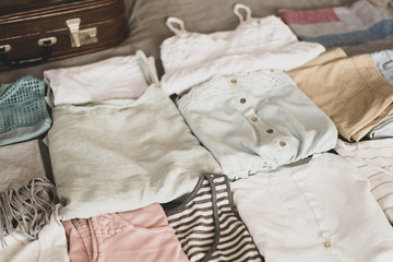 Summer women's clothing neatly folded to be packed in a suitcase. Travel suitcase prepareing concept.