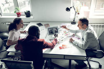 Team working for fashion magazine discussing new issue