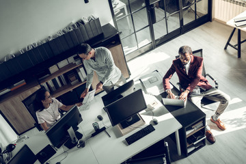 Three successful businessmen working on project together