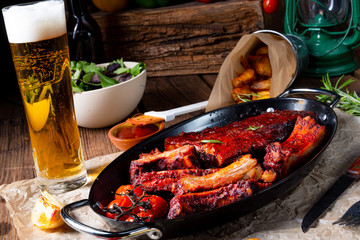 Grilled ribs in spicy marinade with salad and vegetables