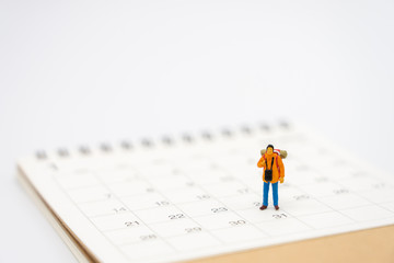 Miniature people stand on a Book Rankings (list) the beginning of the journey To reach the goal. using as background  travel concept with copy spaces for your