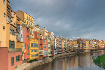 Girona colorful houses reflected in water in river Onyar. Catalonia Spain.