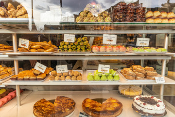 Lots of colorful and tasteful desserts in a patisserie shop