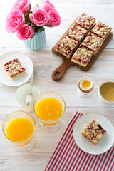 Cake and eggs brunch with coffee and fresh orange juice. White table, high resolution