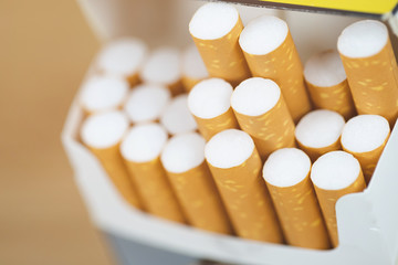 peel it off Cigarette pack prepare smoking a cigarette. Packing line up.  photo filters Natural light. soft focus.