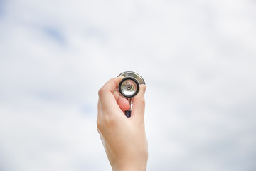 healthcare and medicine concept hand holding stethoscope to the sky.