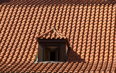 Naklejka premium Dormer window on a red clay tile roof