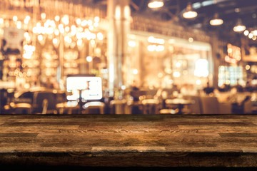 Empty wood table top and blur of night pub or restaurant background/selective focus .For montage product display