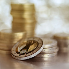 national obverse of the Germanic bimetallic coin 2 euro from copper-nickel alloy on the background of stacks of coins, close-up, macro photo, square