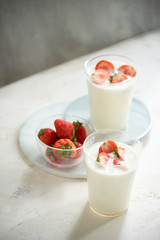 Fresh strawberry on a glass with dessert yogurt and strawberry  on white background