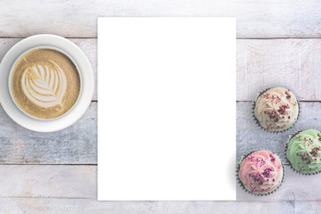 Letter paper next to some cupcakes and a mug with coffee. Empty copy space and love concept. Top...