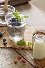Healthy breakfast or morning snack with chia seeds pudding and berries on wooden rustic background, vegetarian food, diet and health concept