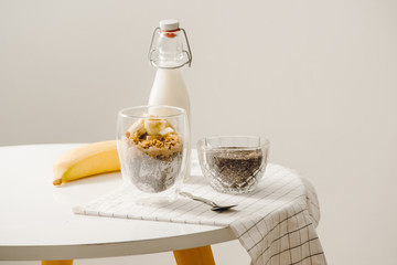 zBanana chia yogurt pudding decorated with ripe sliced banana and peanuts