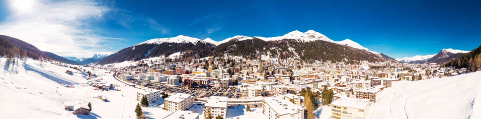 Aerial view of Davos city with ski slopes in the Winter, Grisons, Switzerland