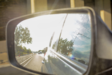 Looking in the wing mirror whilst driving in a car
