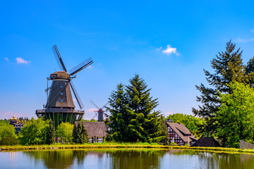 Colorful windmill in Gifhorn of the lake in summer