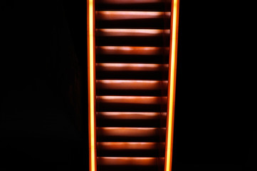 Stairway with orange and yellow lights along steps creating a vector illustration