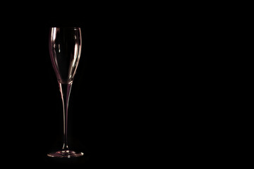 Empty wine glass on the black background low kay