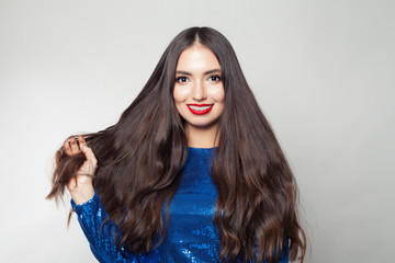Beautiful woman withmakeup and long healthy hair on white background