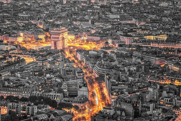 Aerial view of the Arc de Triomphe de l'Etoile (The Triumphal Arch) in Paris at sunset with traffic...