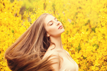 Fototapeta premium Woman with blowing hair portrait. Beautiful girl on fantasy background