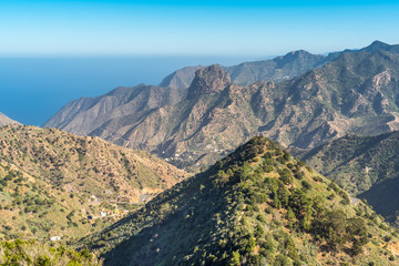 Canyon and jagged mountain range of Vallehermoso what means the beautiful valley in english. View to the Roque Cano, a famous volcanic neck on the north side of La Gomera