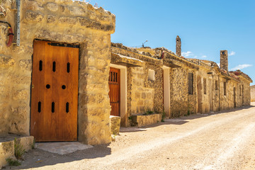 Spanish village street with traditional wineries (Baltanás, Castilla y Leon, Spain)