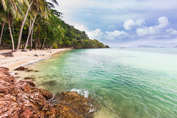 Fototapeta na wymiar Beautiful rocky on seashore in tropical beach of Koh Wai, Trat province, Thailand.