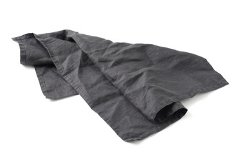 Side view on dark black linen napkin isolated on white background. Anthracite grey linen napkin. Isolated on white with clipping path.