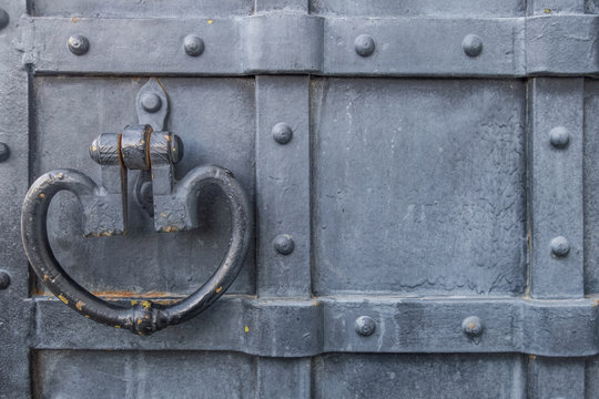 Background Of Old Metal Upholstered Painted In Black Door With Wrought Antique Handle Close Up