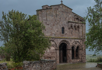 Fototapeta na wymiar Romanesque church near Alghero (L'Alguer), province of Sassari , Sardinia, Italy. Famous for the beauty of its coast and beaches and its historical city center.