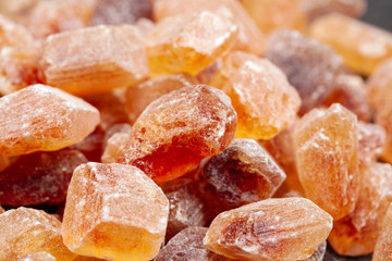 brown sugar rock organic crystalline close up on dark background