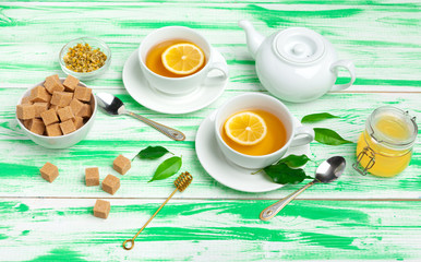 Black tea on green wooden background