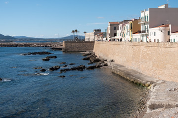 Fototapeta na wymiar Gorgeous sea font and ramparts, Alghero (L'Alguer), province of Sassari , Sardinia, Italy. Famous for the beauty of its coast and beaches and its historical city center.