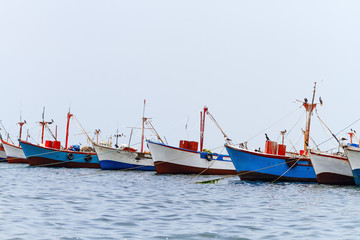 Fototapeta na wymiar Colored fishing boats in Paracas, Peru