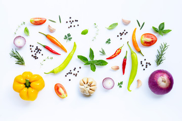 Various fresh vegetables and herbs on white background.