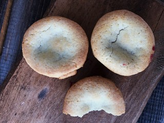 Delicious cupcakes with cherry jam on a wooden stand