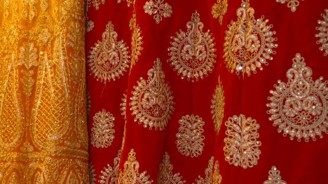 Beautiful colorful tissue with traditional embroidery in the shop on the street Delhi, India. Shot in motion