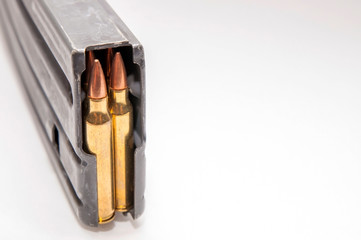A rifle magazine loaded with 556 bullets on a white background with room for text