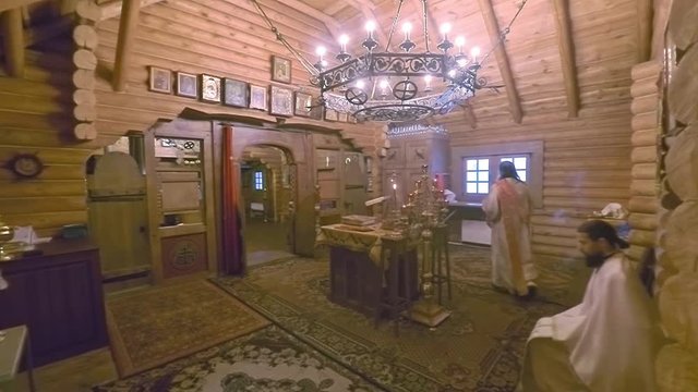 Christian divine service in an orthodox wooden Russian church