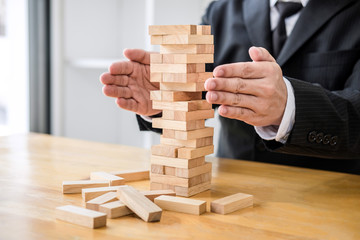 Alternative risk concept, plan and strategy in business protect with balance wooden stack with hand...