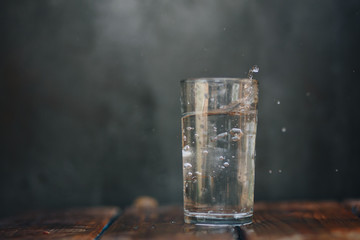 Splashing water from crystal glass On the wood floor
