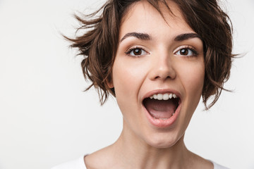 Portrait closeup of cute woman with short brown hair in basic t-shirt smiling at camera