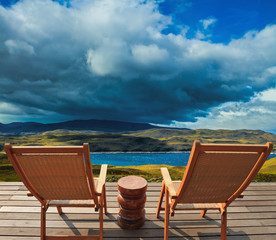 Two sun loungers on the shore