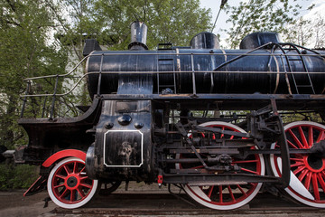 Fototapeta na wymiar Old black train with big red wheels . Retro train.